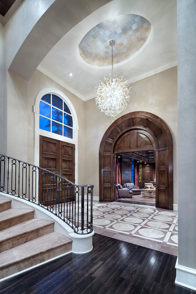 Expansive transitional foyer in Houston with beige walls, dark hardwood floors, a double front door and a medium wood front door.