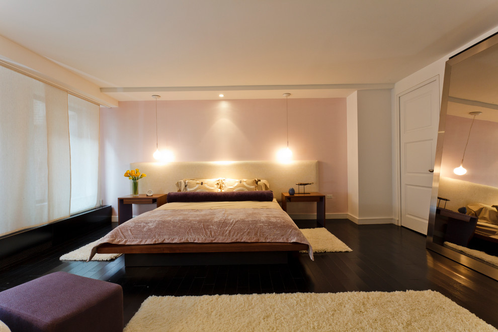 Large trendy master dark wood floor bedroom photo in New York with white walls and no fireplace