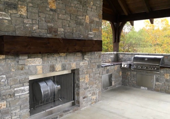 Inspiration for a mid-sized transitional backyard concrete patio kitchen remodel with a roof extension