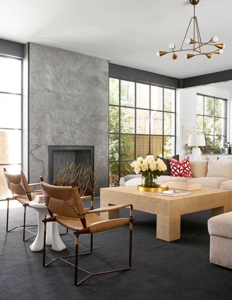 This is an example of a contemporary living room in Dallas with a standard fireplace and a concrete fireplace surround.