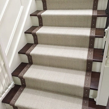 This is an example of a large modern carpeted u-shaped metal railing staircase in Chicago with carpeted risers.