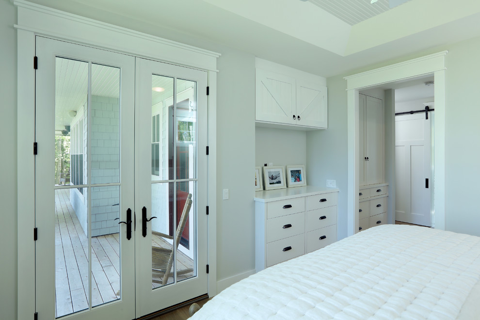 Design ideas for a small country master bedroom in Other with grey walls, light hardwood floors and brown floor.
