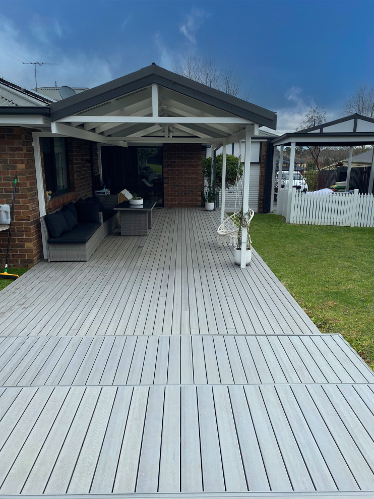Design ideas for a large contemporary backyard and ground level deck in Melbourne with a pergola.