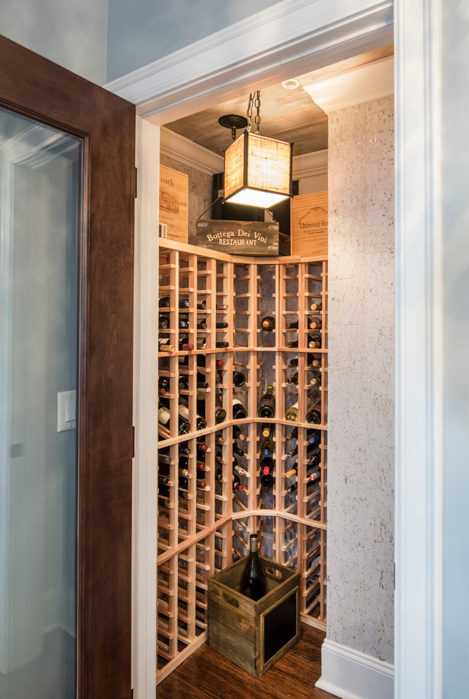Design ideas for a small beach style wine cellar in Other with medium hardwood floors and storage racks.