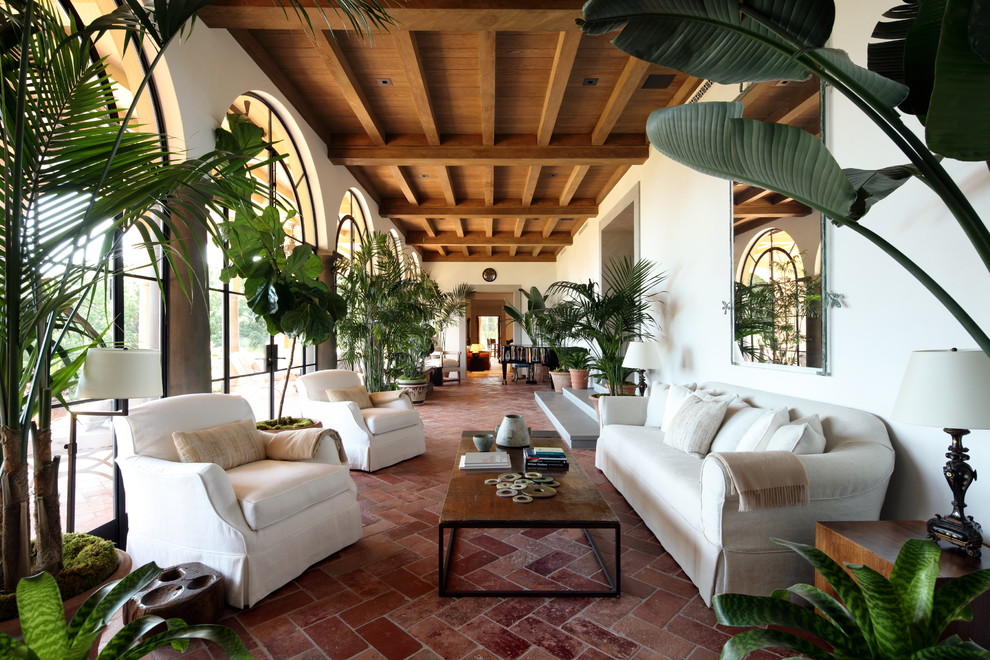 Design ideas for a mediterranean sunroom in Los Angeles with terra-cotta floors, orange floor and a standard ceiling.