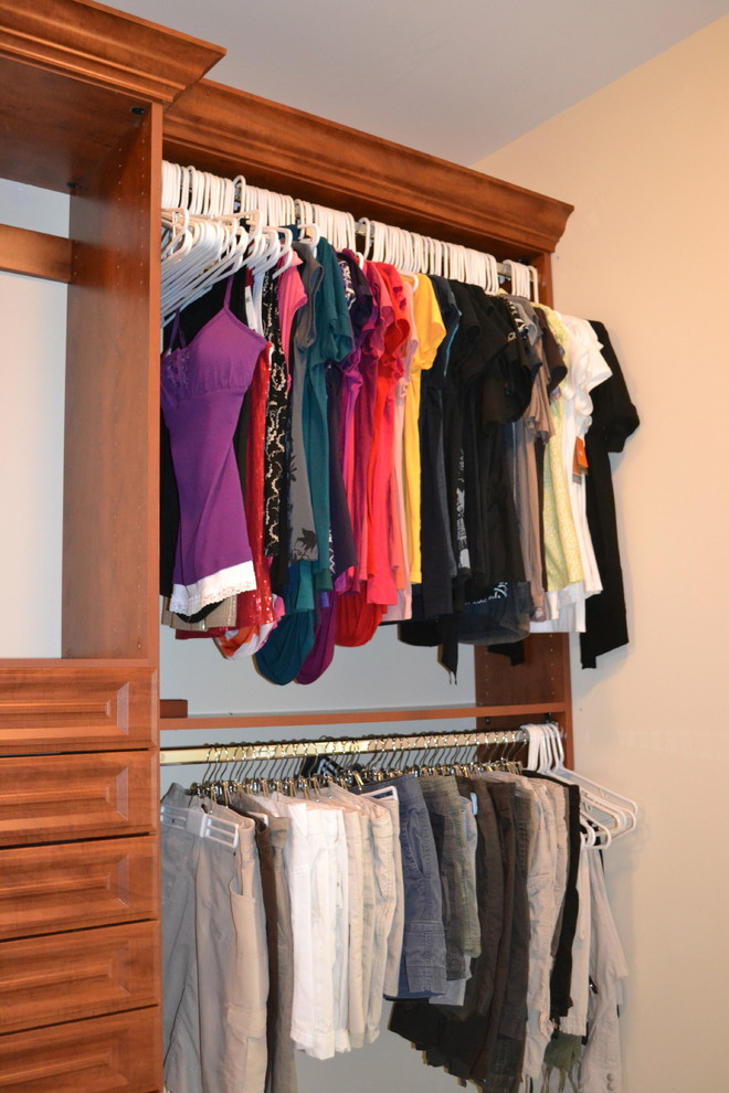 Inspiration for a large traditional gender-neutral walk-in wardrobe in Indianapolis with raised-panel cabinets and medium wood cabinets.