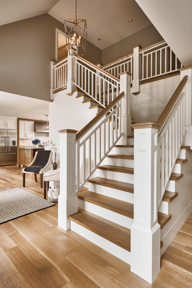 This is an example of a transitional wood l-shaped staircase in Vancouver with wood risers and wood railing.