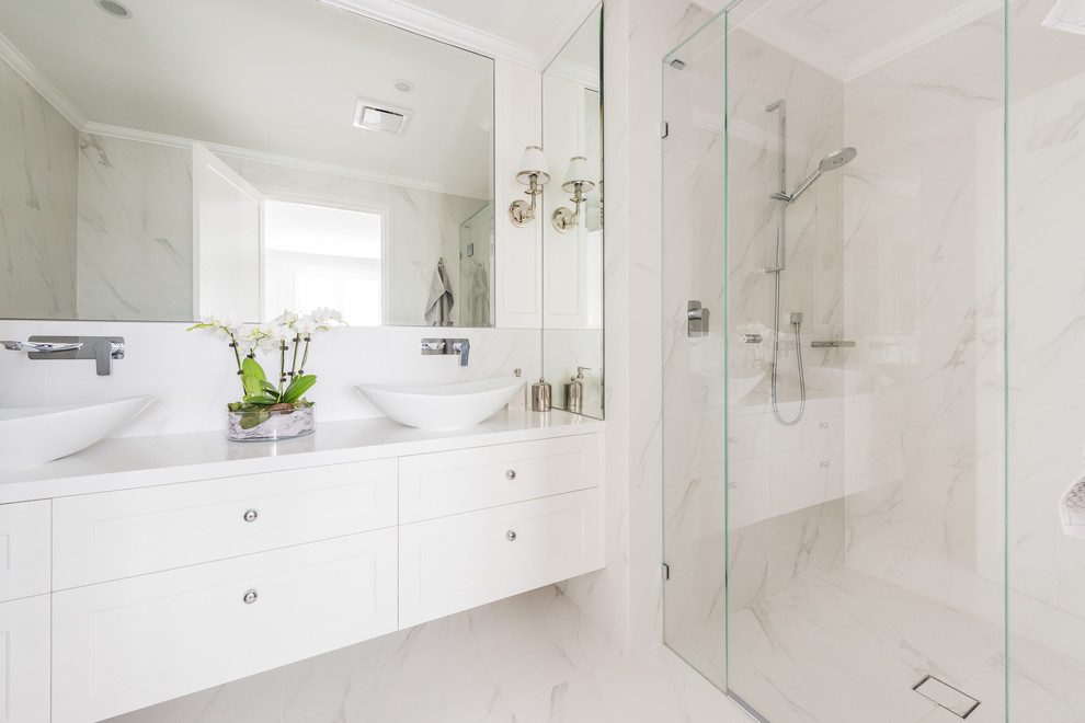 Design ideas for a transitional 3/4 bathroom in Melbourne with shaker cabinets, white cabinets, a corner shower, white walls, a vessel sink, beige floor, a hinged shower door and white benchtops.