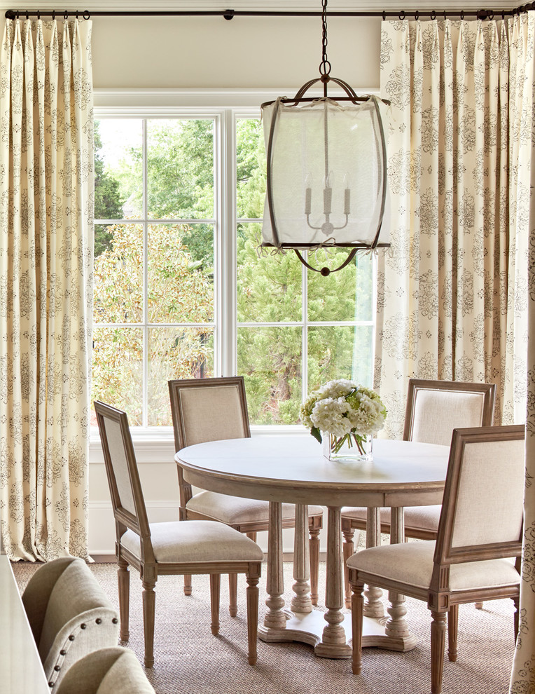 This is an example of a traditional dining room in Charlotte with beige walls.