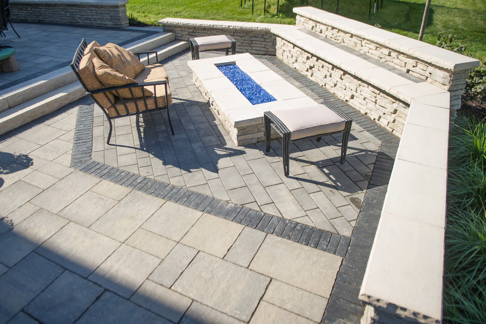 Inspiration for a transitional backyard patio in Columbus with an outdoor kitchen and concrete pavers.