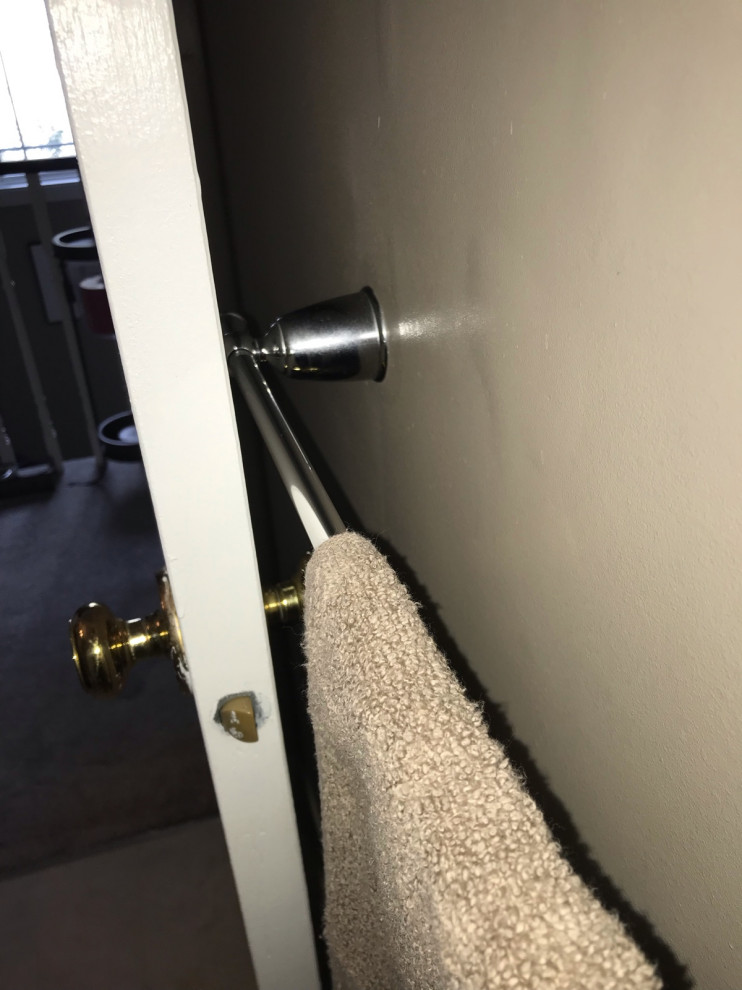 Bathroom door hits towel bar