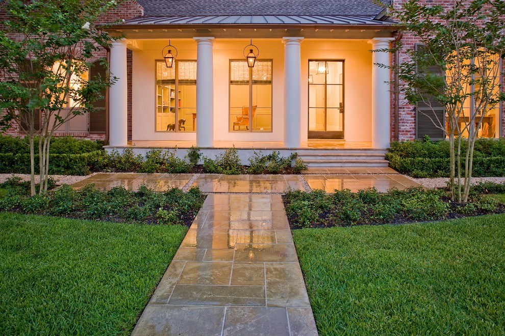 Inspiration for a mid-sized traditional front yard full sun garden for fall in Houston with a garden path and concrete pavers.