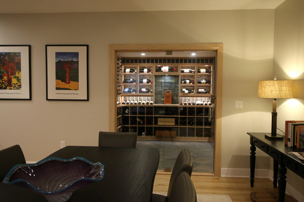 This is an example of a large traditional wine cellar in Cincinnati with slate floors and display racks.