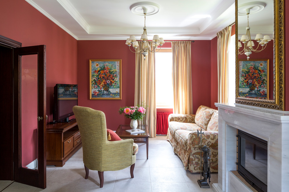 Traditional formal open concept living room in Moscow with red walls and a freestanding tv.