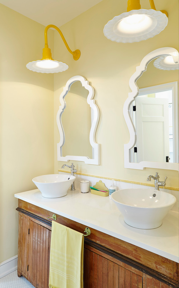 This is an example of a beach style bathroom in Minneapolis with a vessel sink, distressed cabinets, white tile and yellow walls.
