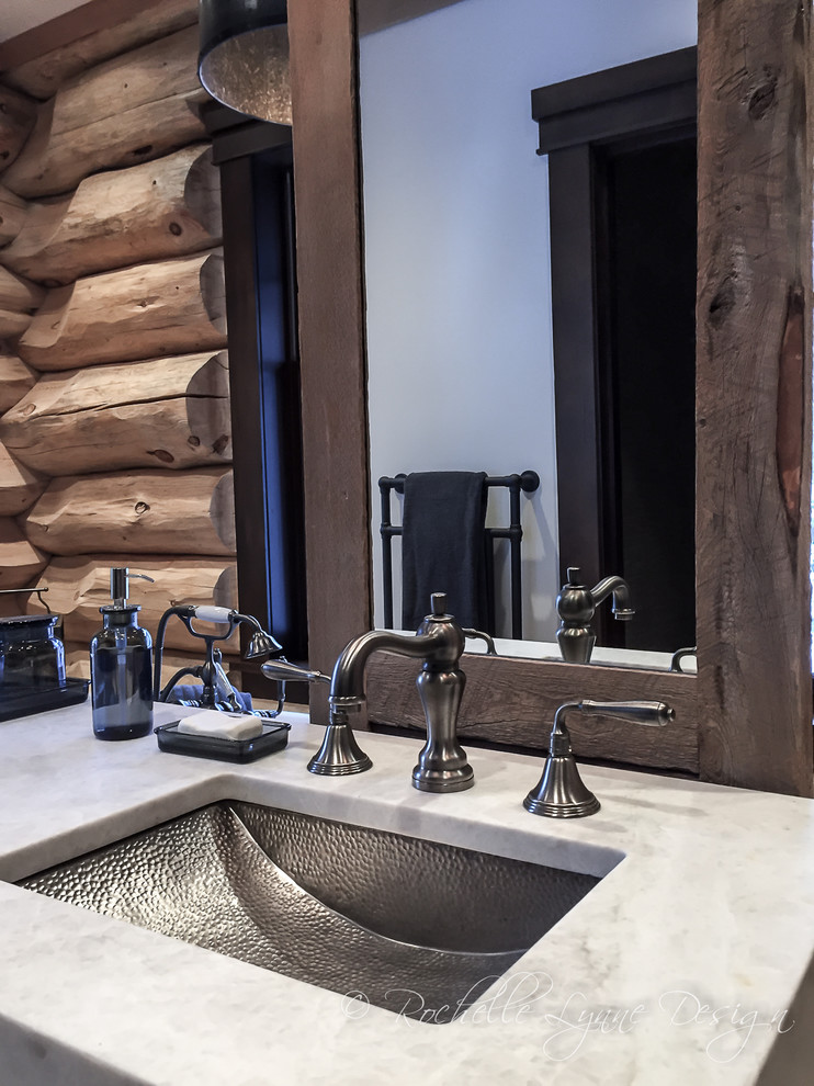 Example of a large mountain style master freestanding bathtub design in Calgary with shaker cabinets, light wood cabinets, an undermount sink and granite countertops