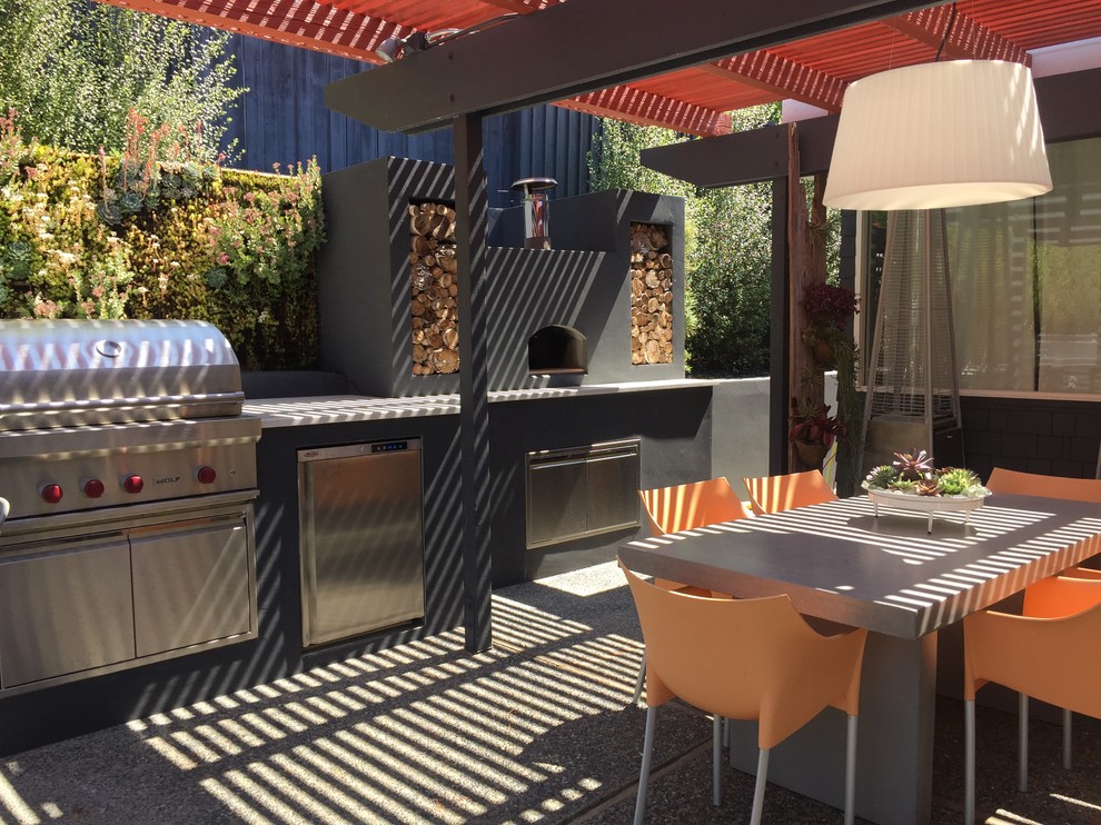 Inspiration for a mid-sized asian backyard patio in San Francisco with an outdoor kitchen, gravel and a roof extension.