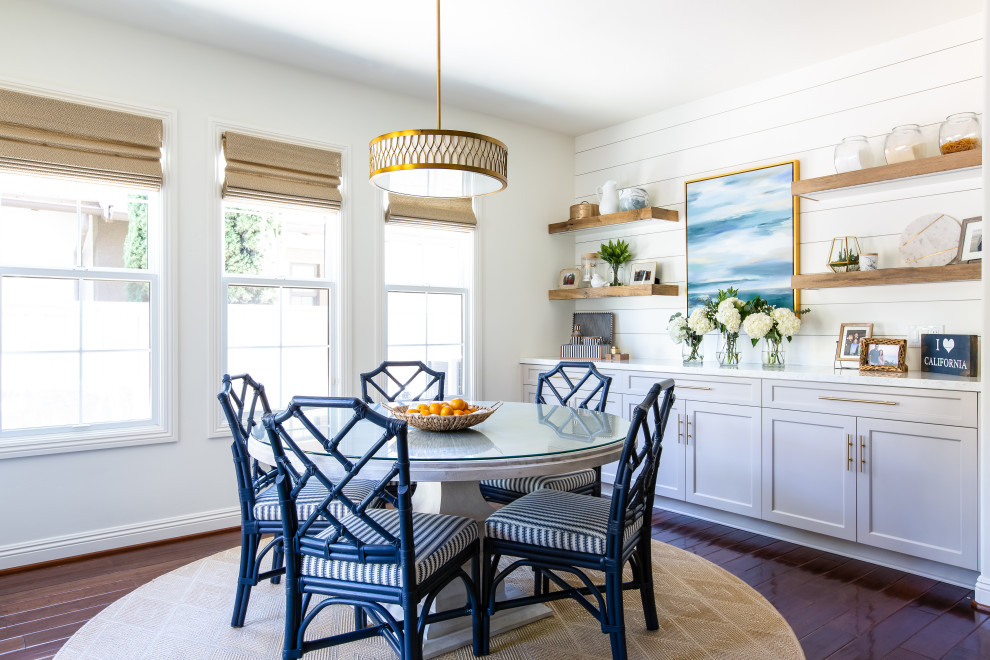 Design ideas for a mid-sized beach style dining room in San Diego with white walls, dark hardwood floors, brown floor and planked wall panelling.