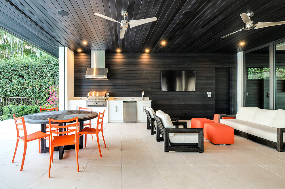 Contemporary backyard patio in Orlando with an outdoor kitchen and a roof extension.