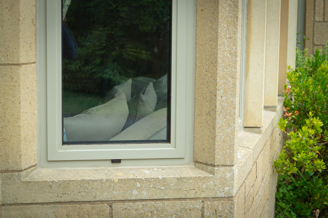 RAL 7032 Pebble Grey windows with a Timber door exterior