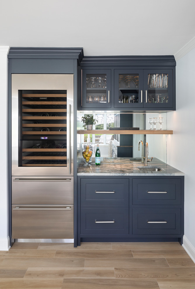 Inspiration for a mid-sized transitional single-wall wet bar in Bridgeport with an undermount sink, shaker cabinets, blue cabinets, quartzite benchtops, glass tile splashback, porcelain floors, beige floor and multi-coloured benchtop.