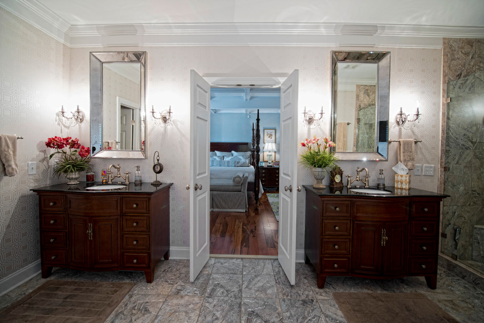 Inspiration for a mid-sized traditional master bathroom in Other with raised-panel cabinets, dark wood cabinets, a drop-in tub, an open shower, a one-piece toilet, black tile, stone tile, beige walls, ceramic floors, a drop-in sink and solid surface benchtops.