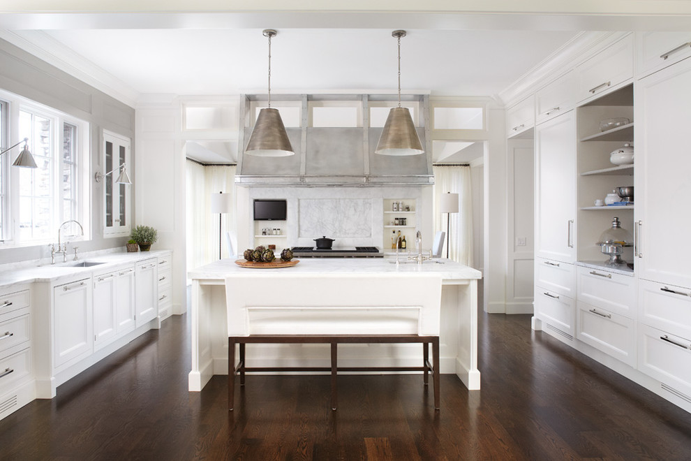This is an example of a transitional kitchen in Chicago with an undermount sink, recessed-panel cabinets, white cabinets, white splashback, dark hardwood floors, with island and brown floor.