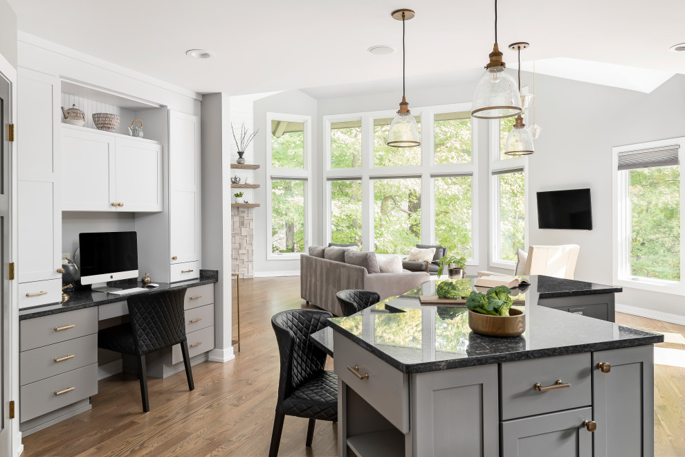 Large transitional medium tone wood floor open concept kitchen photo in Chicago with an undermount sink, shaker cabinets, white cabinets, granite countertops, gray backsplash, marble backsplash, stainless steel appliances, an island and black countertops