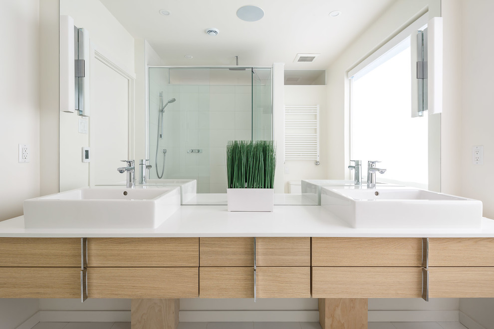 Mid-sized modern master bathroom in Ottawa with flat-panel cabinets, light wood cabinets, an alcove shower, a one-piece toilet, white tile, porcelain tile, white walls, a vessel sink and a hinged shower door.