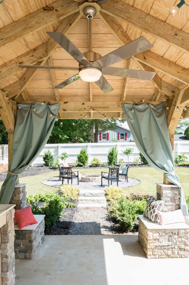 Inspiration for a mid-sized traditional backyard patio in Houston with a fire feature, gravel and a gazebo/cabana.