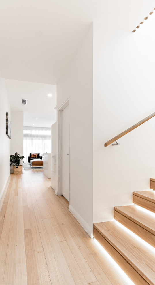 Inspiration for a mid-sized contemporary wood u-shaped staircase in Sydney with wood risers and wood railing.