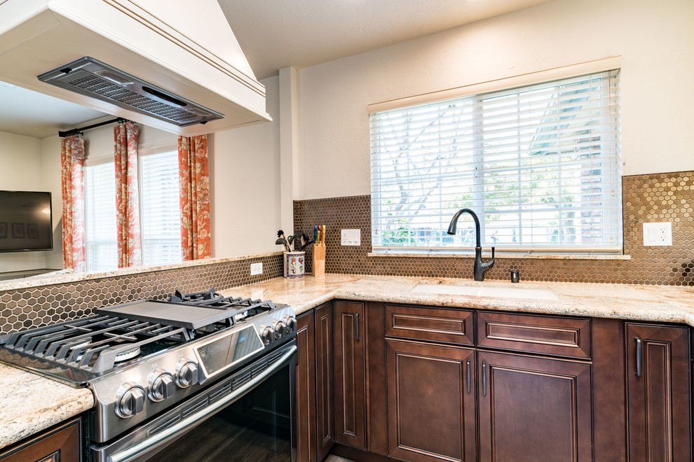 Mid-sized transitional u-shaped medium tone wood floor and brown floor eat-in kitchen photo with an undermount sink, recessed-panel cabinets, white cabinets, granite countertops, brown backsplash, mosaic tile backsplash, stainless steel appliances and no island
