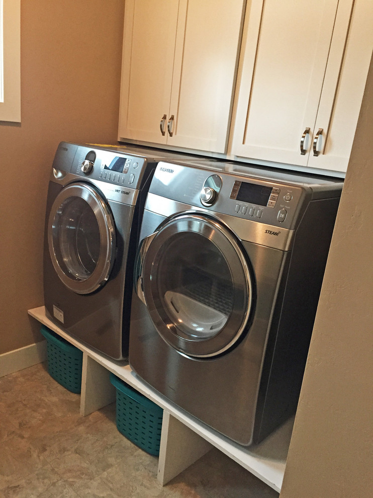 This is an example of a mid-sized contemporary dedicated laundry room in Other with white cabinets, laminate benchtops, a side-by-side washer and dryer and shaker cabinets.