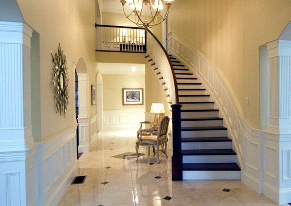 Design ideas for a mid-sized traditional wood curved staircase in Other with painted wood risers and wood railing.