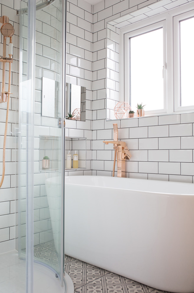 Photo of a small eclectic kids bathroom in Other with flat-panel cabinets, light wood cabinets, a freestanding tub, a corner shower, a one-piece toilet, white tile, subway tile, white walls, ceramic floors, a wall-mount sink, grey floor and a sliding shower screen.