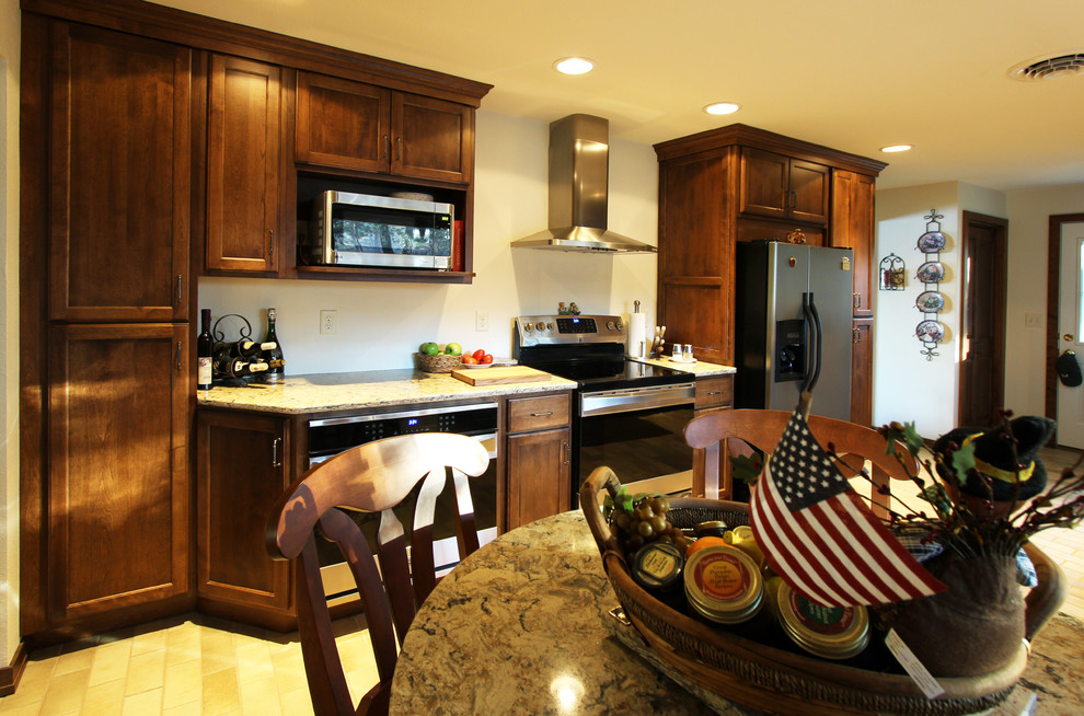Mid-sized kitchen photo with flat-panel cabinets, medium tone wood cabinets, quartz countertops, stainless steel appliances and no island