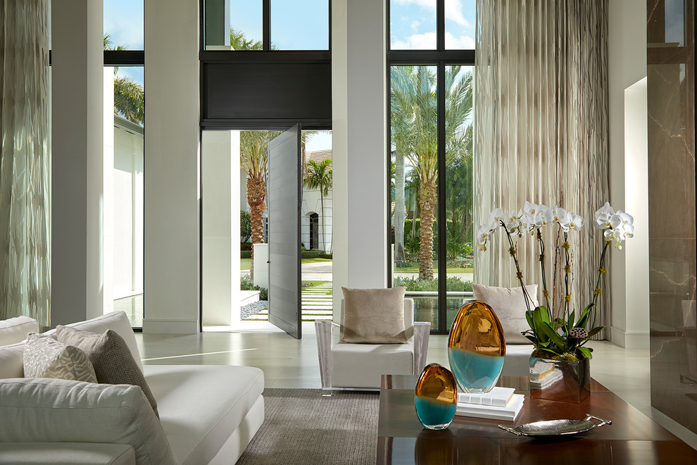 This is an example of an expansive contemporary family room in Miami with marble floors.