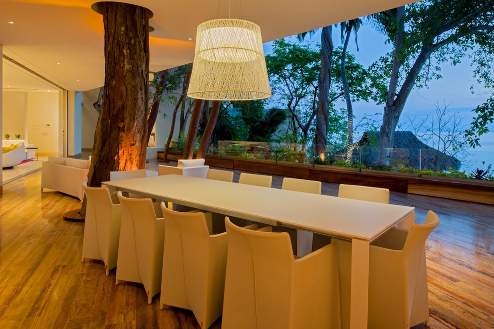 Expansive beach style dining room in Other.