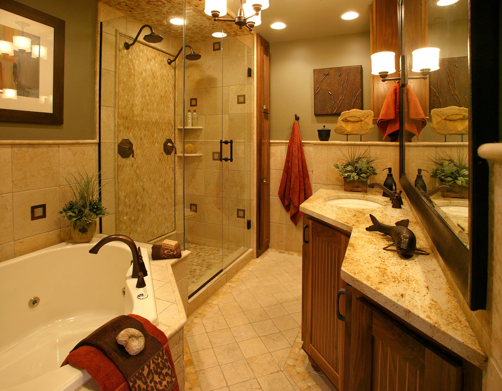Mid-sized mediterranean master bathroom in Minneapolis with an undermount sink, medium wood cabinets, granite benchtops, a corner tub, a double shower, beige tile, stone tile, grey walls, ceramic floors and recessed-panel cabinets.