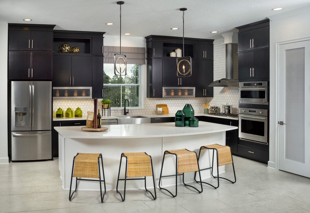 Design ideas for a transitional l-shaped kitchen in Jacksonville with a farmhouse sink, flat-panel cabinets, black cabinets, multi-coloured splashback, stainless steel appliances, with island, grey floor and white benchtop.