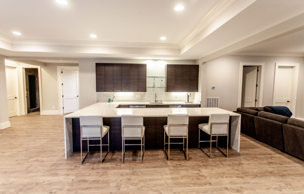 Example of a large transitional look-out light wood floor and brown floor basement design in Atlanta with gray walls