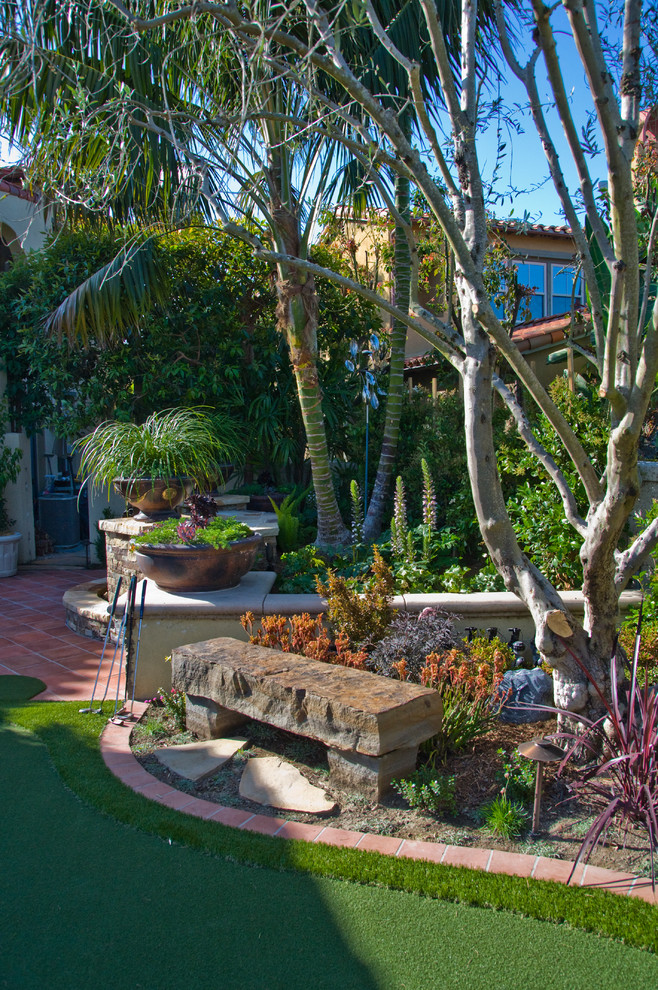 This is an example of a mediterranean backyard garden in Orange County.