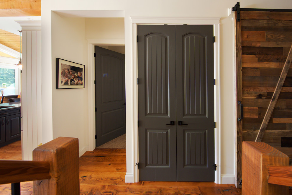Hallway - small rustic medium tone wood floor hallway idea in Vancouver with white walls