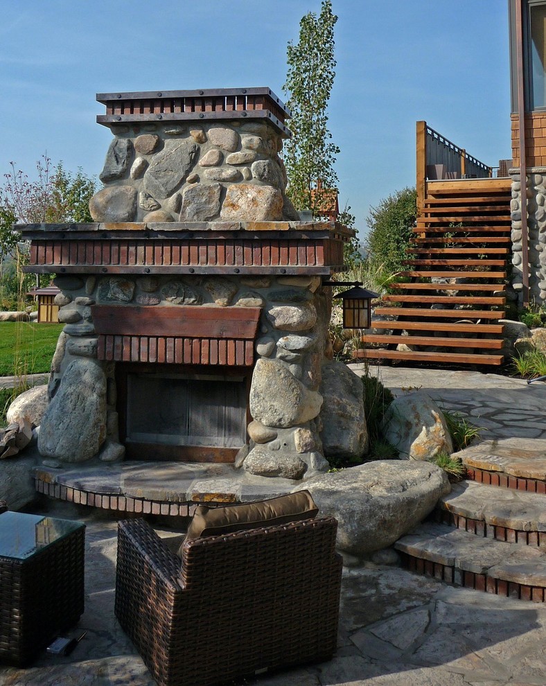 Design ideas for an arts and crafts patio in Calgary with a fire feature.