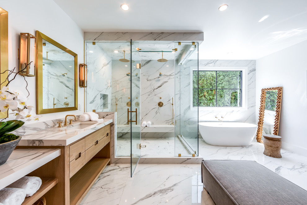 This is an example of a transitional 3/4 bathroom in Los Angeles with flat-panel cabinets, light wood cabinets, a freestanding tub, a double shower, white walls, an undermount sink, a hinged shower door and grey benchtops.