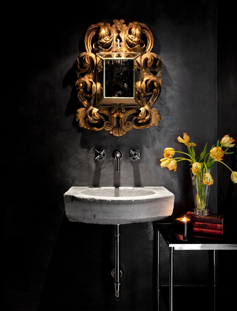 Powder room - mediterranean powder room idea in Austin with a wall-mount sink and black walls