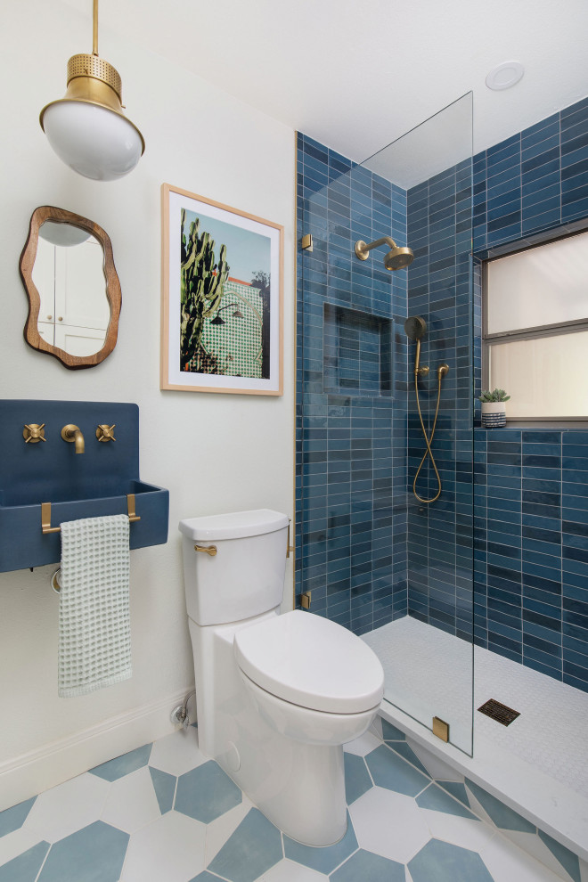 Inspiration for a mid-sized transitional blue tile cement tile floor, blue floor and single-sink open shower remodel in Austin with blue cabinets, a two-piece toilet, white walls, a wall-mount sink, concrete countertops, blue countertops and a floating vanity