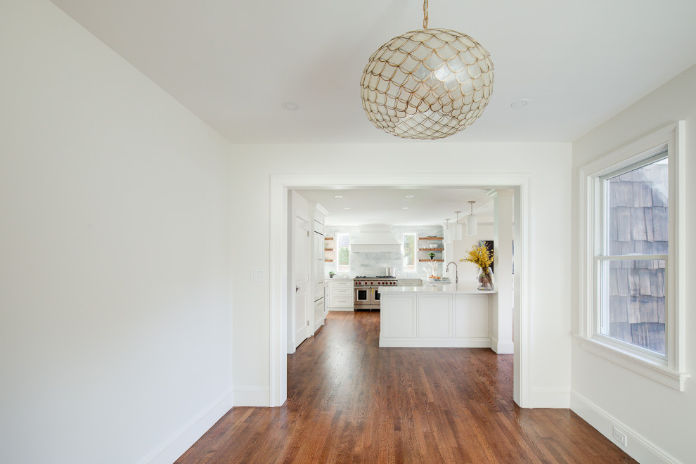 Example of a mid-sized transitional u-shaped medium tone wood floor and brown floor open concept kitchen design with a farmhouse sink, recessed-panel cabinets, white cabinets, quartz countertops, multicolored backsplash, marble backsplash, stainless steel appliances, a peninsula and white countertops