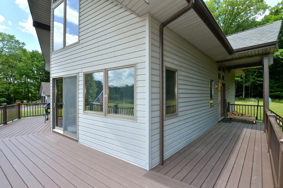 Deck - large rustic second story mixed material railing deck idea with no cover