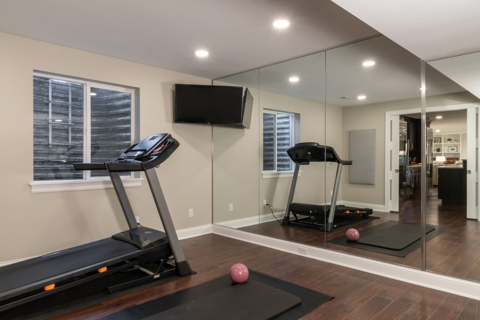 Transitional home gym in St Louis with grey walls and brown floor.